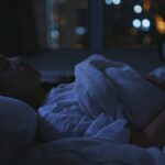 Woman suffer from insomnia on bed at night