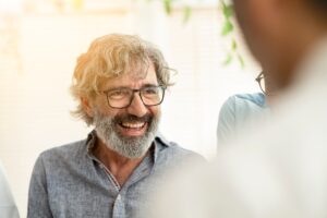 senior businessman smiling with work group